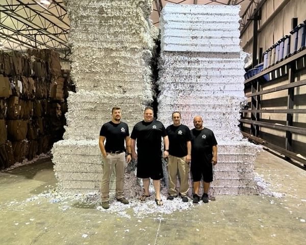 Tab Group Inc - Team with shredded paper & document stacks